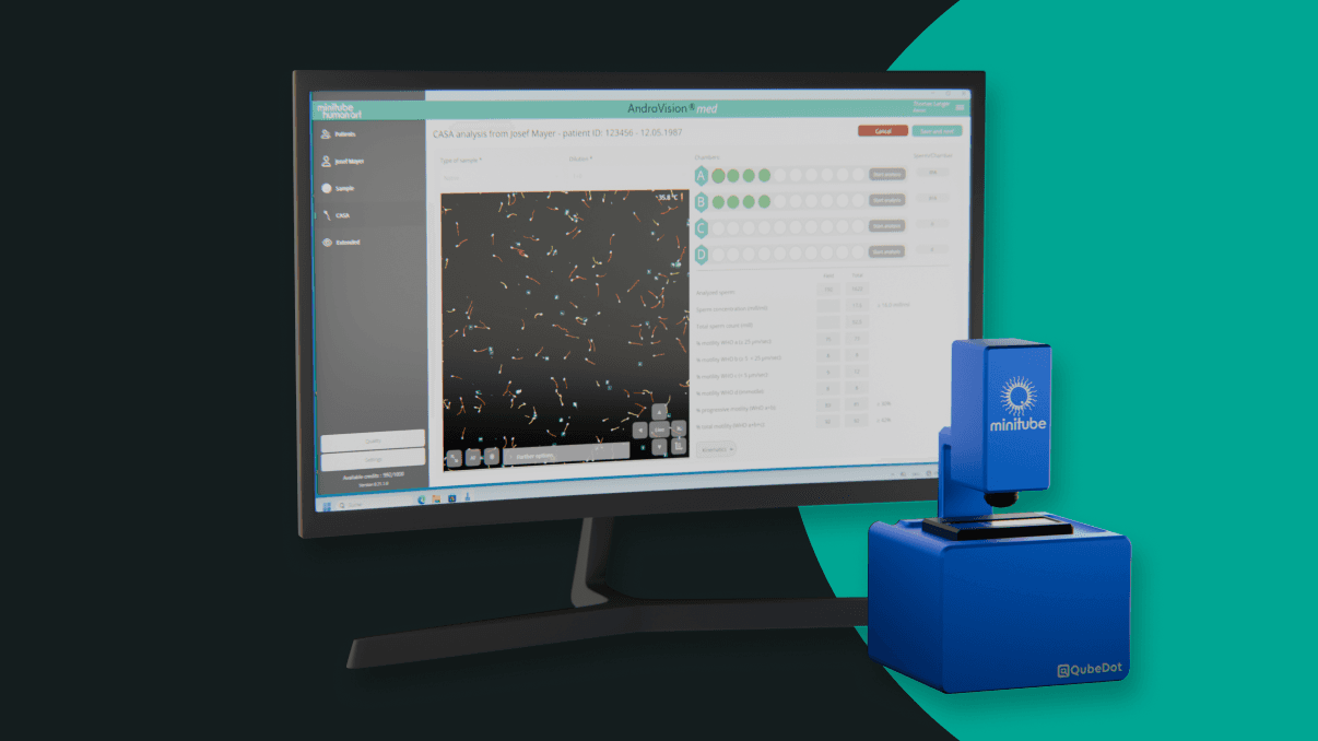 A computer monitor displaying the AndroVision med CASA software interface alongside the blue MiniQube digital microscope for automated sperm analysis.